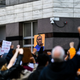Demonstrators raise their fists as they protest outside the Hennepin County Government Center at the trial of former Minneapolis Police officer Derek Chauvin on March 8, 2021 in Minneapolis, Minnesota.